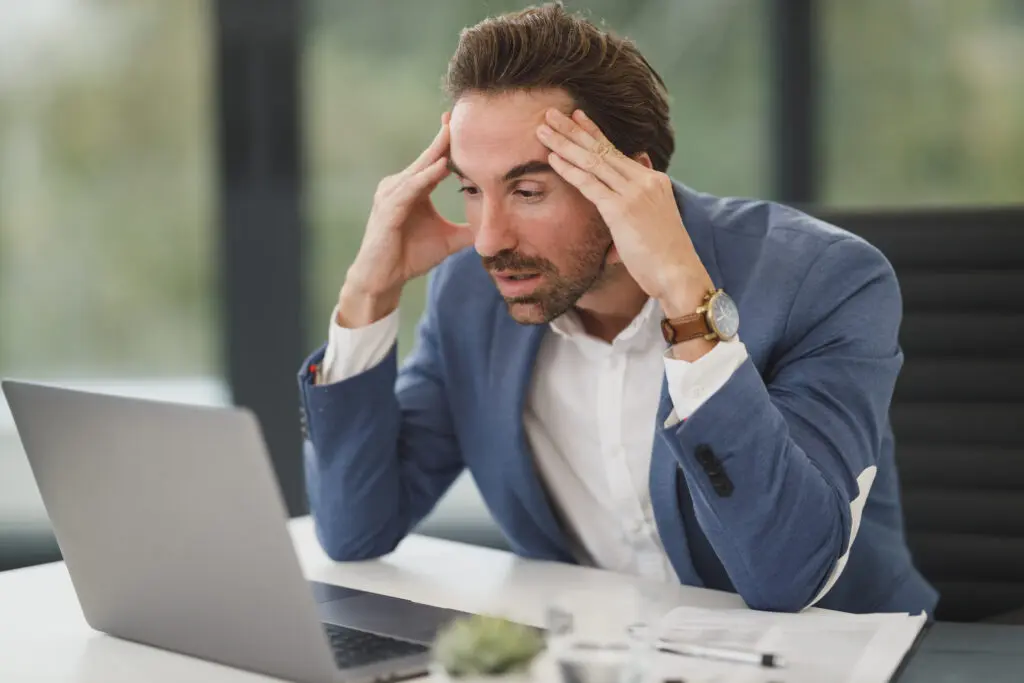 Career Cancel, cancel that boring career, person looking stressed while working on a laptop